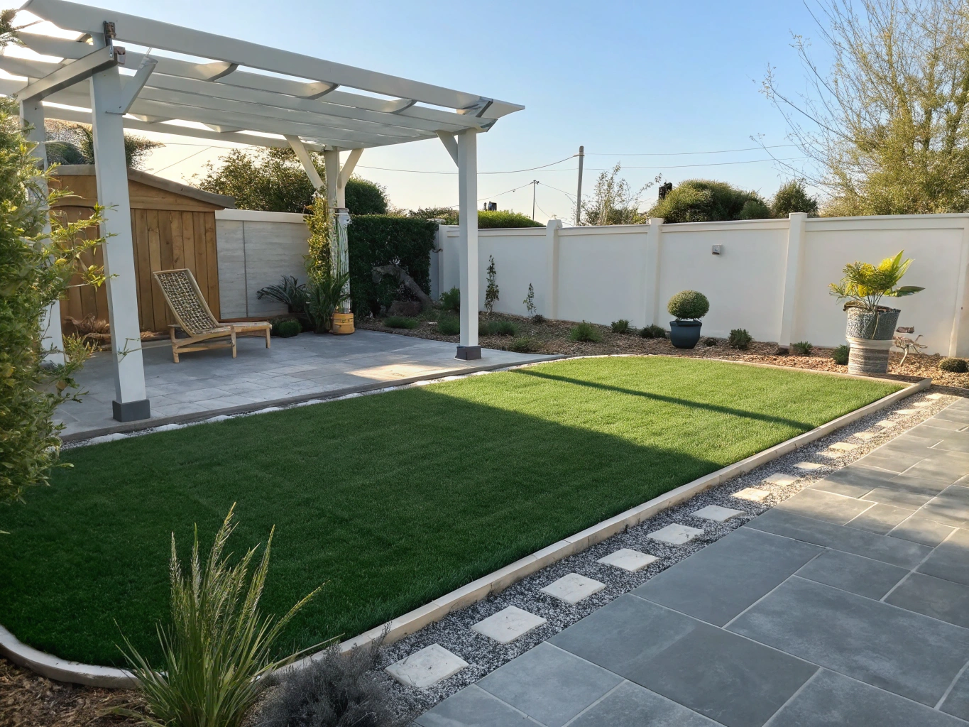 Covered outdoor patio accented with soft artificial grass and stone paver walkways