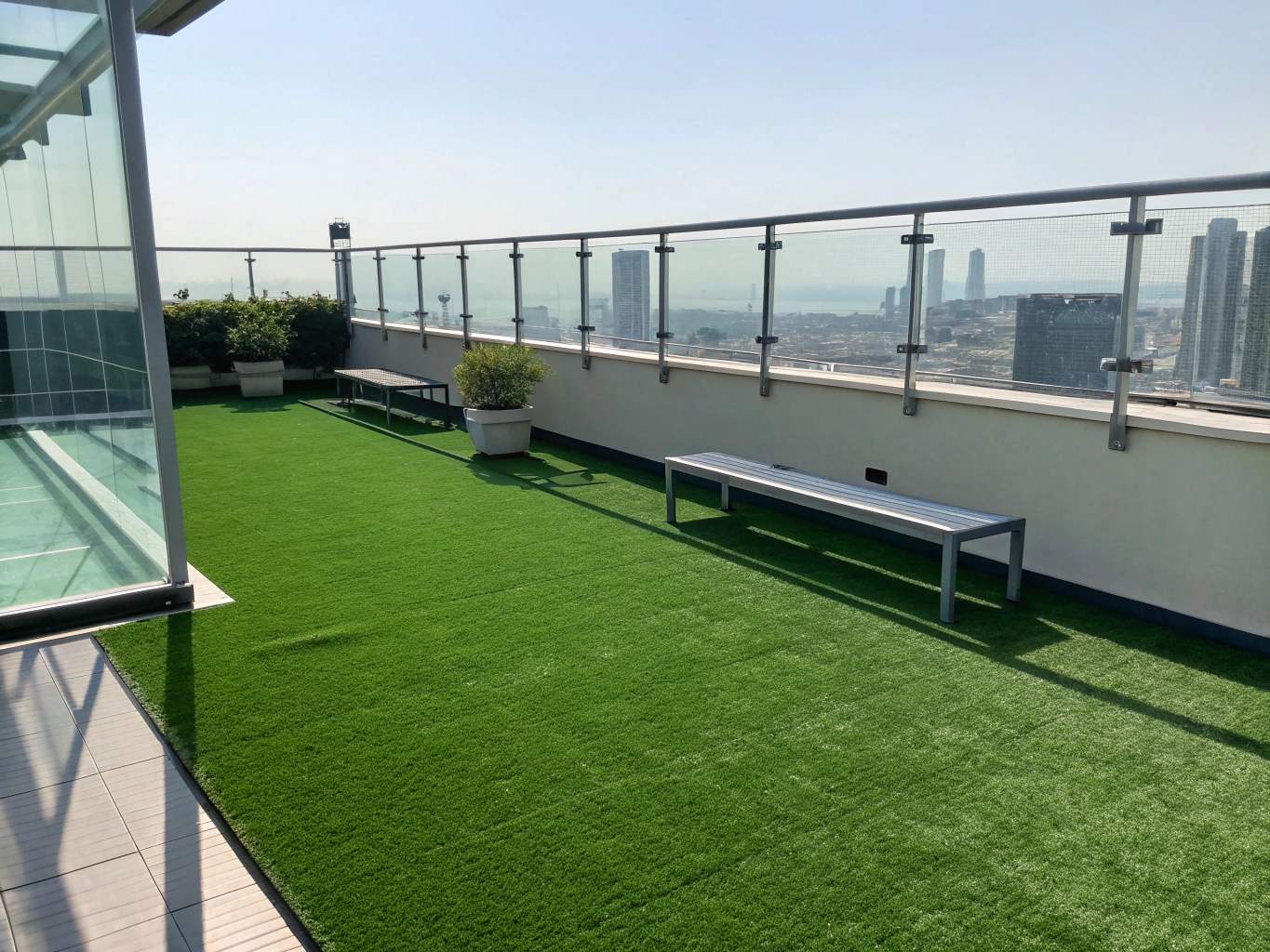 Rooftop lounge deck with clean green artificial turf and outdoor patio seating
