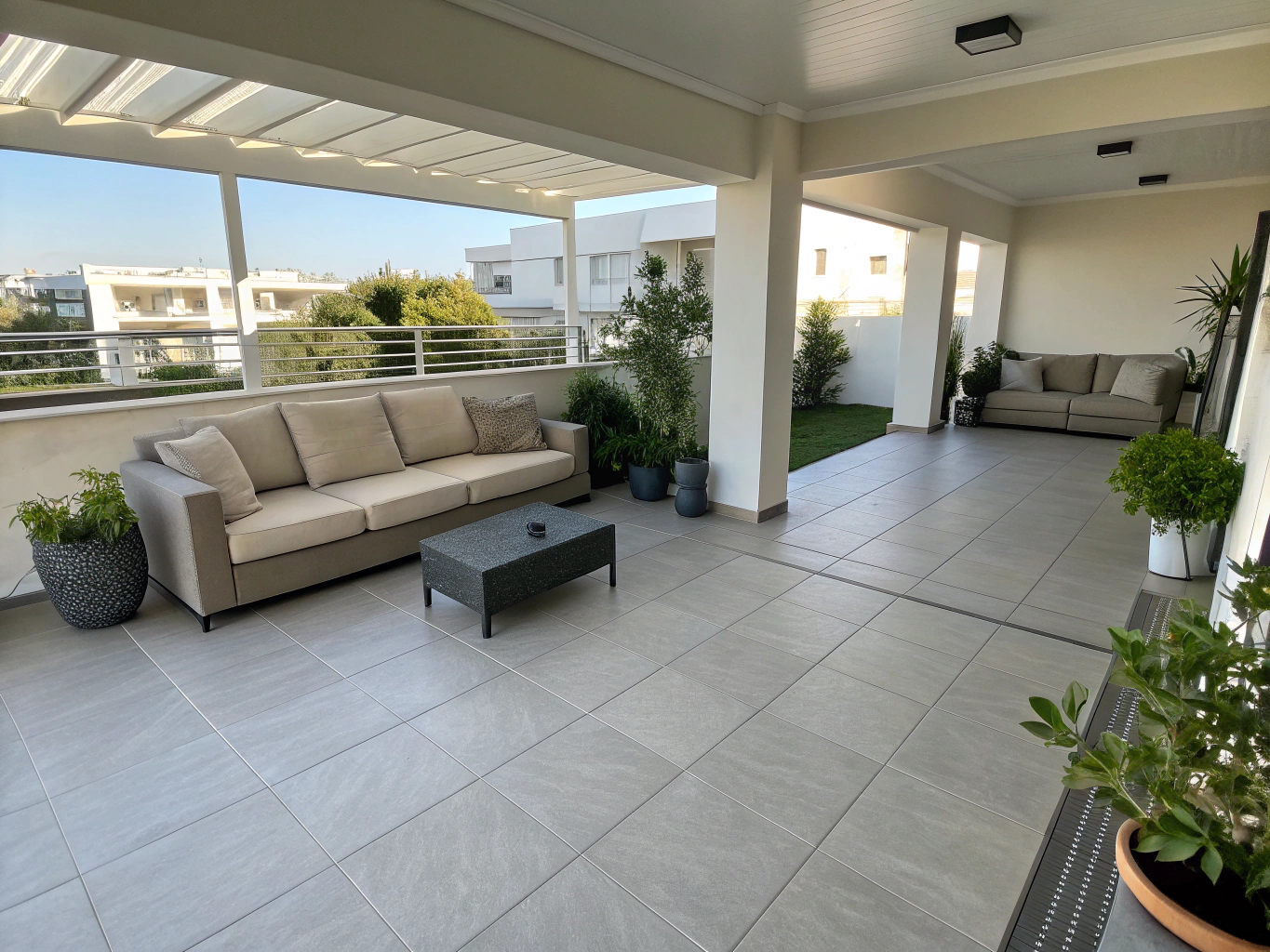 Large modern terrace featuring synthetic grass borders and lounge furniture