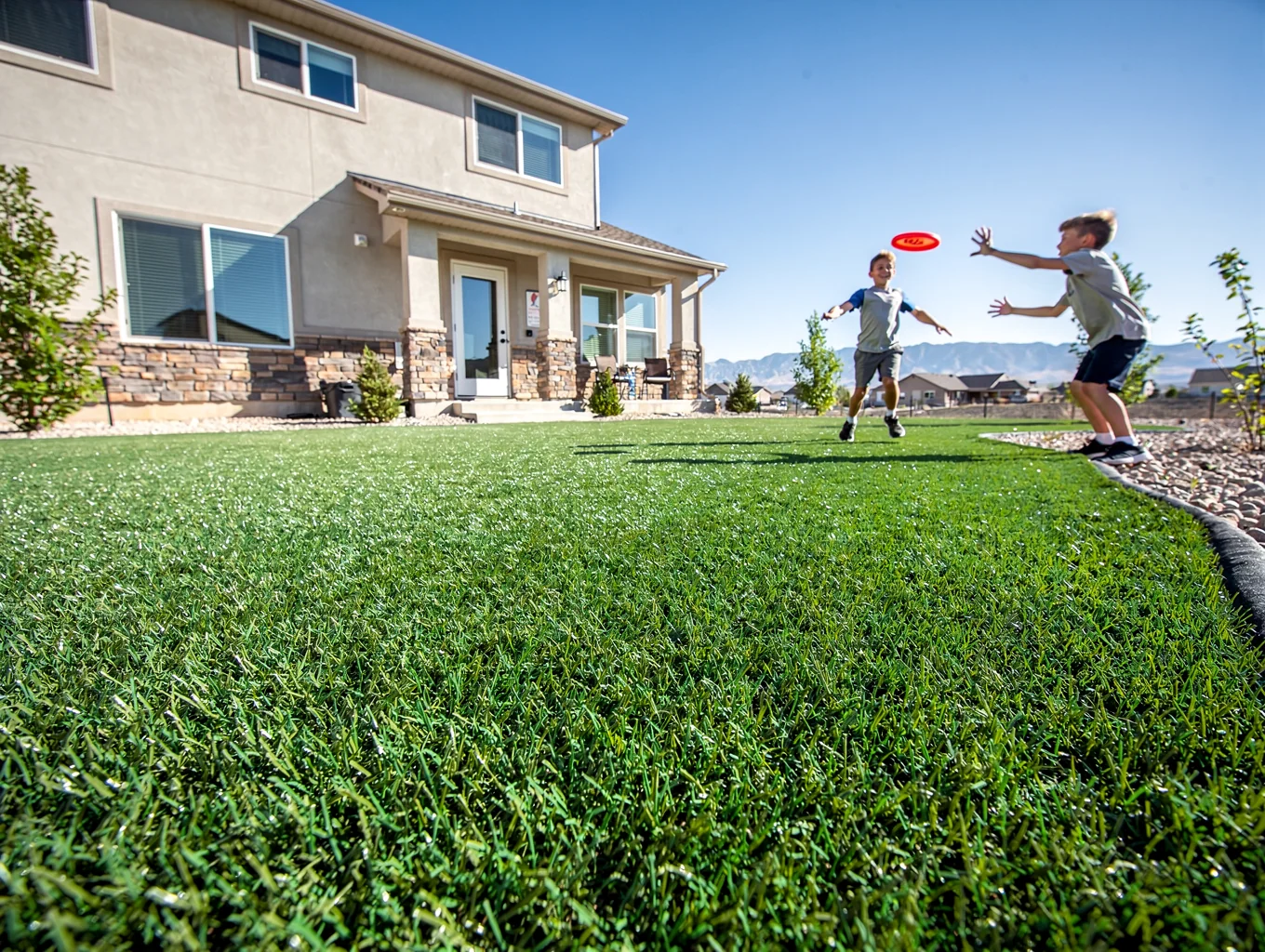 Front yard lawn with synthetic turf installation in a residential neighborhood