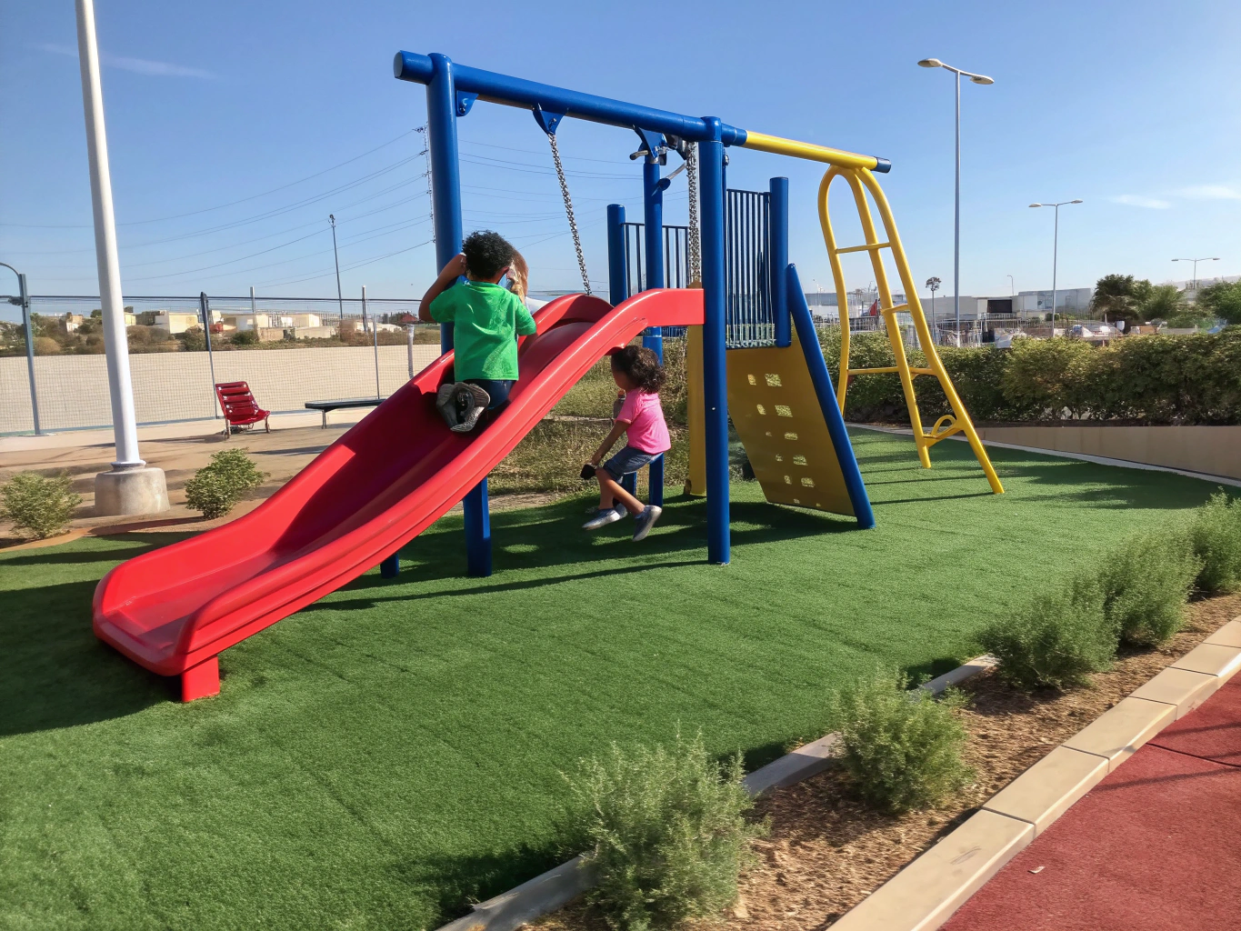 Safe artificial turf installed beneath playground swings and climbing structures