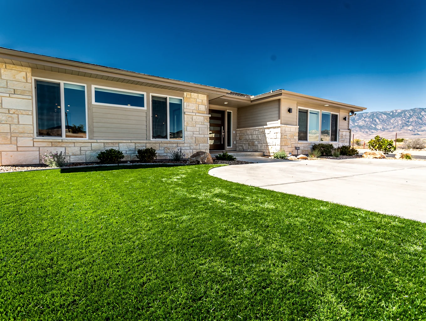 Modern residential front yard featuring freshly installed artificial grass in a suburban Texas neighborhood