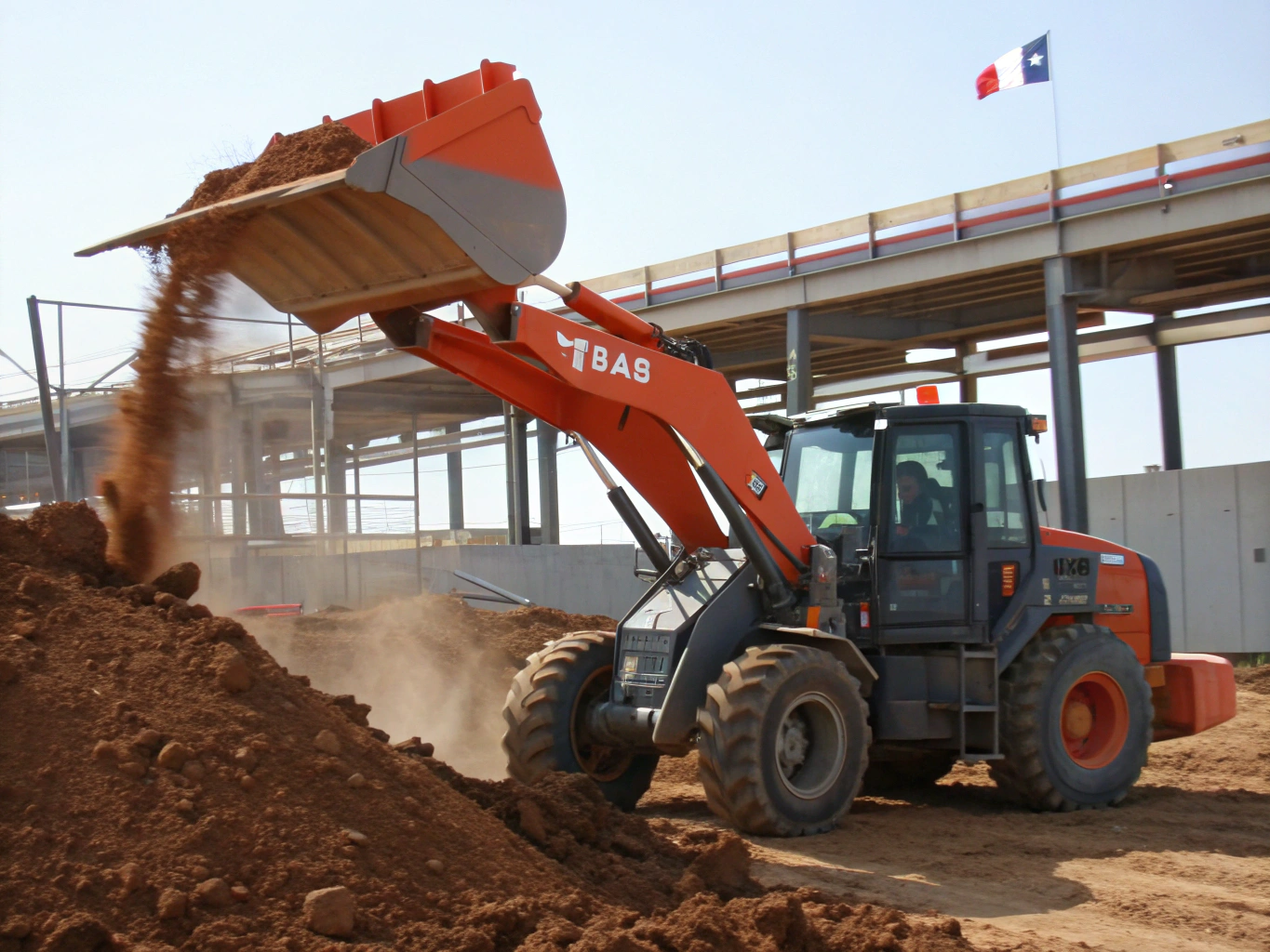 Excavator digging out heavy clay soil during lawn prep